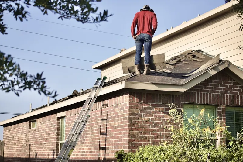 Professional roofer working on a residential roof in Columbia Forest
